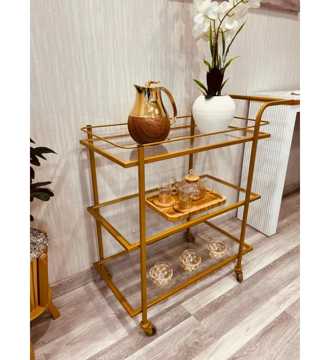 A glass serving cart with golden iron edges, 3 floors, with easy-to-move wheels (90*40*92) cm