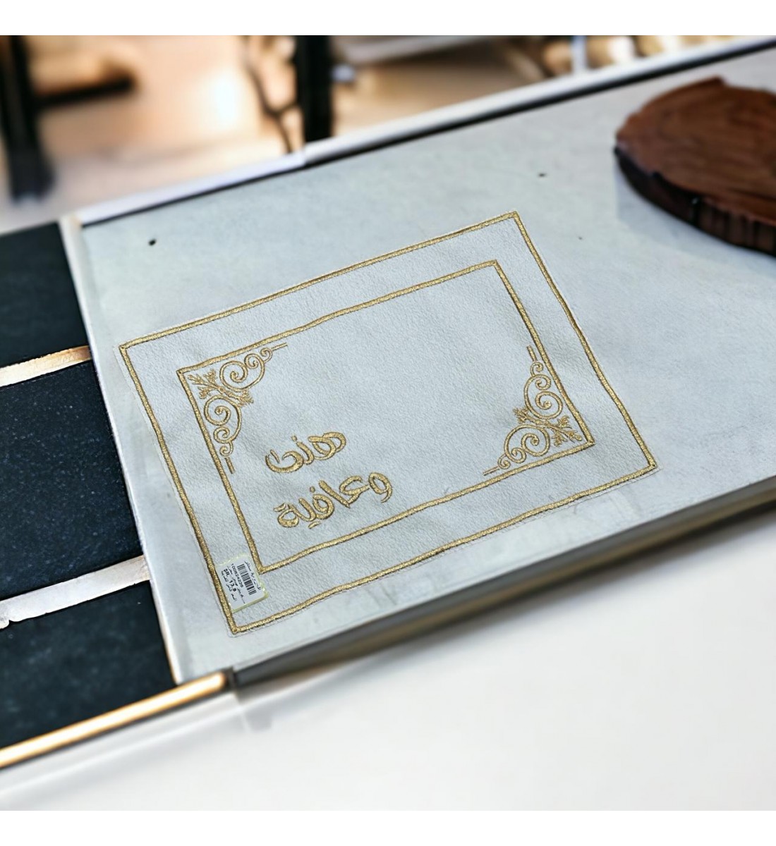 Golden tablecloths with the phrase “Hanaa and Wellness”.