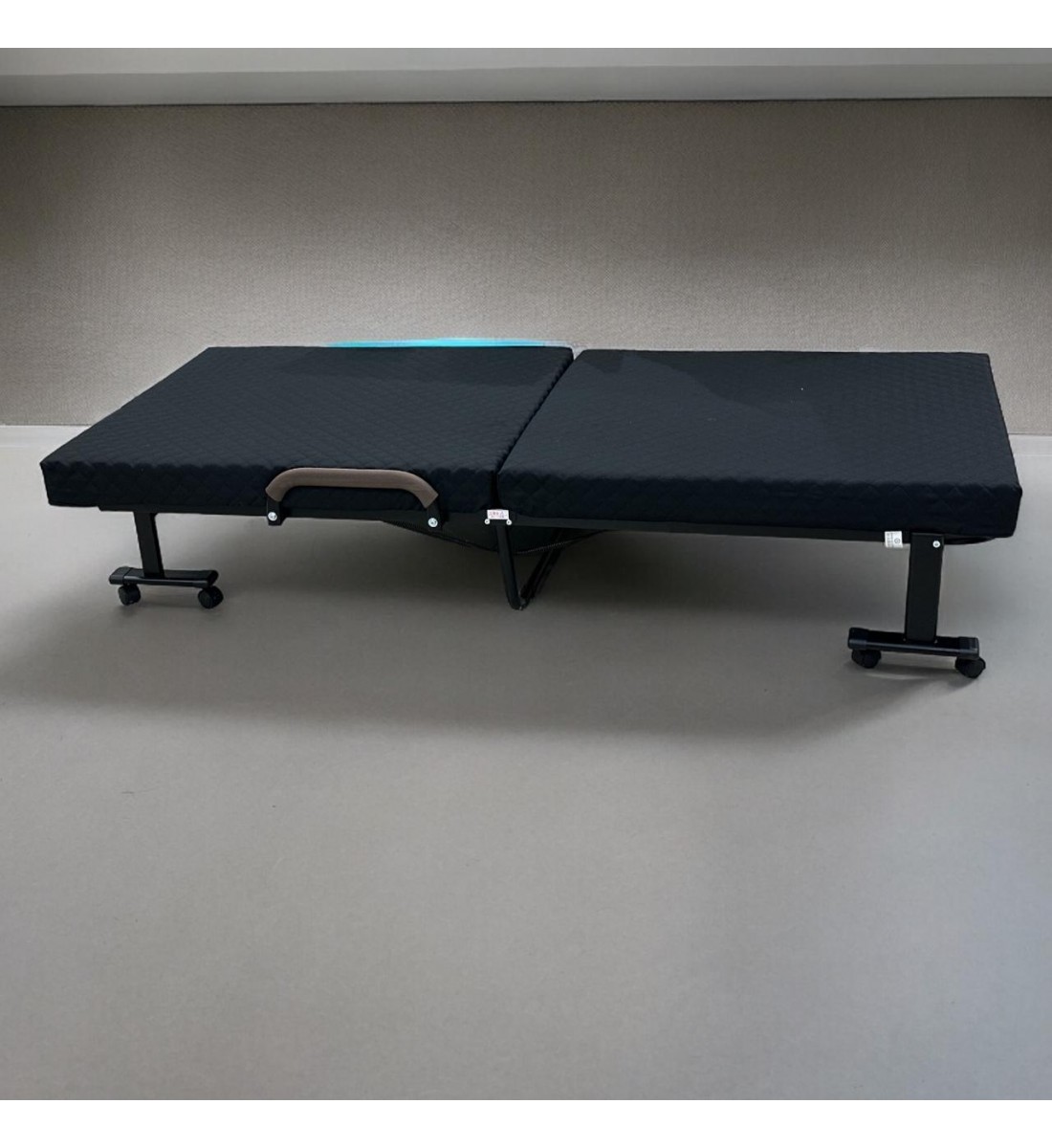 Bed with foldable mattress and movable wheels, black
