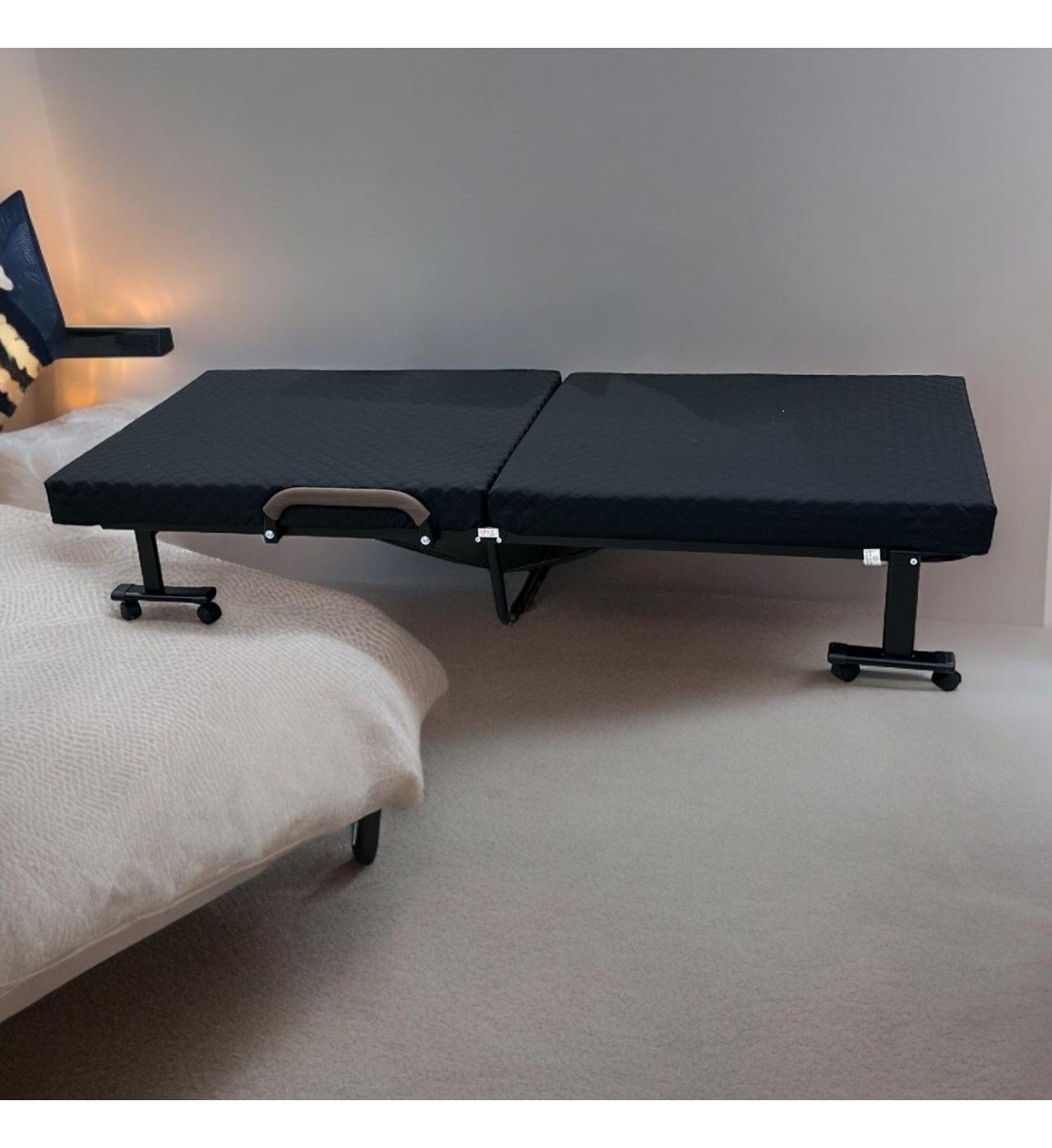 Bed with foldable mattress and movable wheels, black
