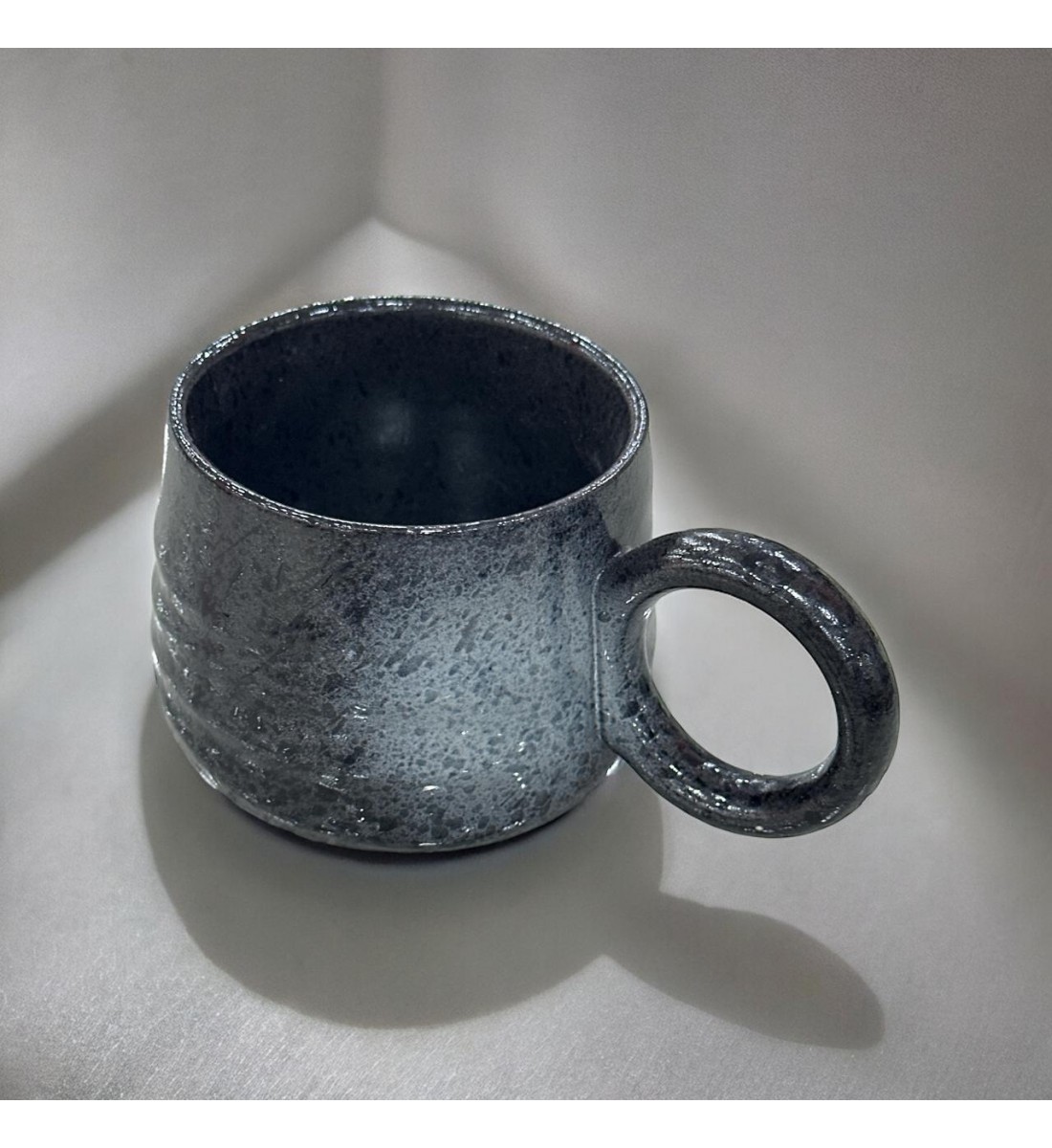 Ceramic mug with black colored handle