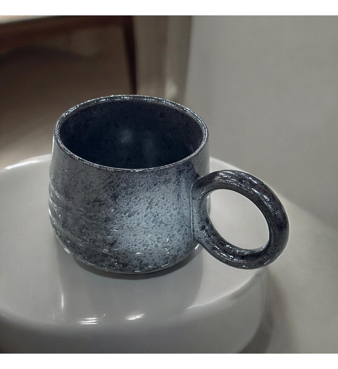 Ceramic mug with black colored handle