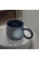 Ceramic mug with black colored handle