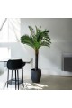 A tree decorated with palm leaves, a black stand, approximately 3 cm high
