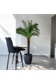 A tree decorated with palm leaves, a black stand, approximately 3 cm high