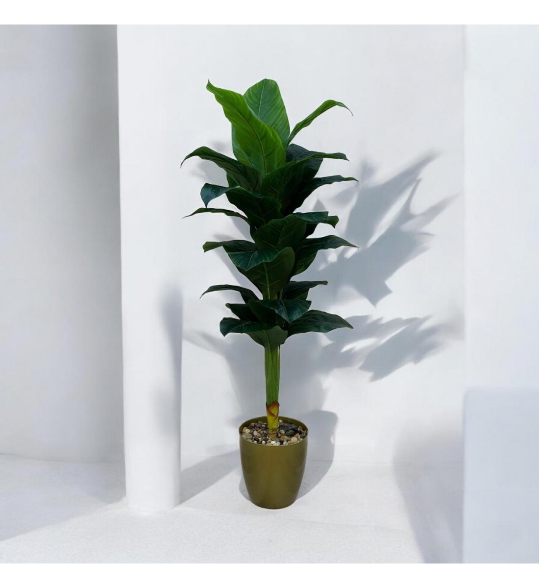 A tree decorated with a golden banana, approximately 140 cm