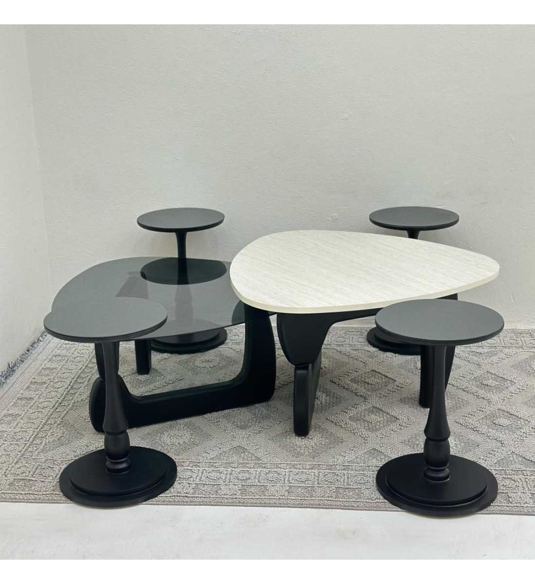 6-piece table set, the first table top is a marble alternative with a smooth texture, and the second table top is glass with black wooden bases.