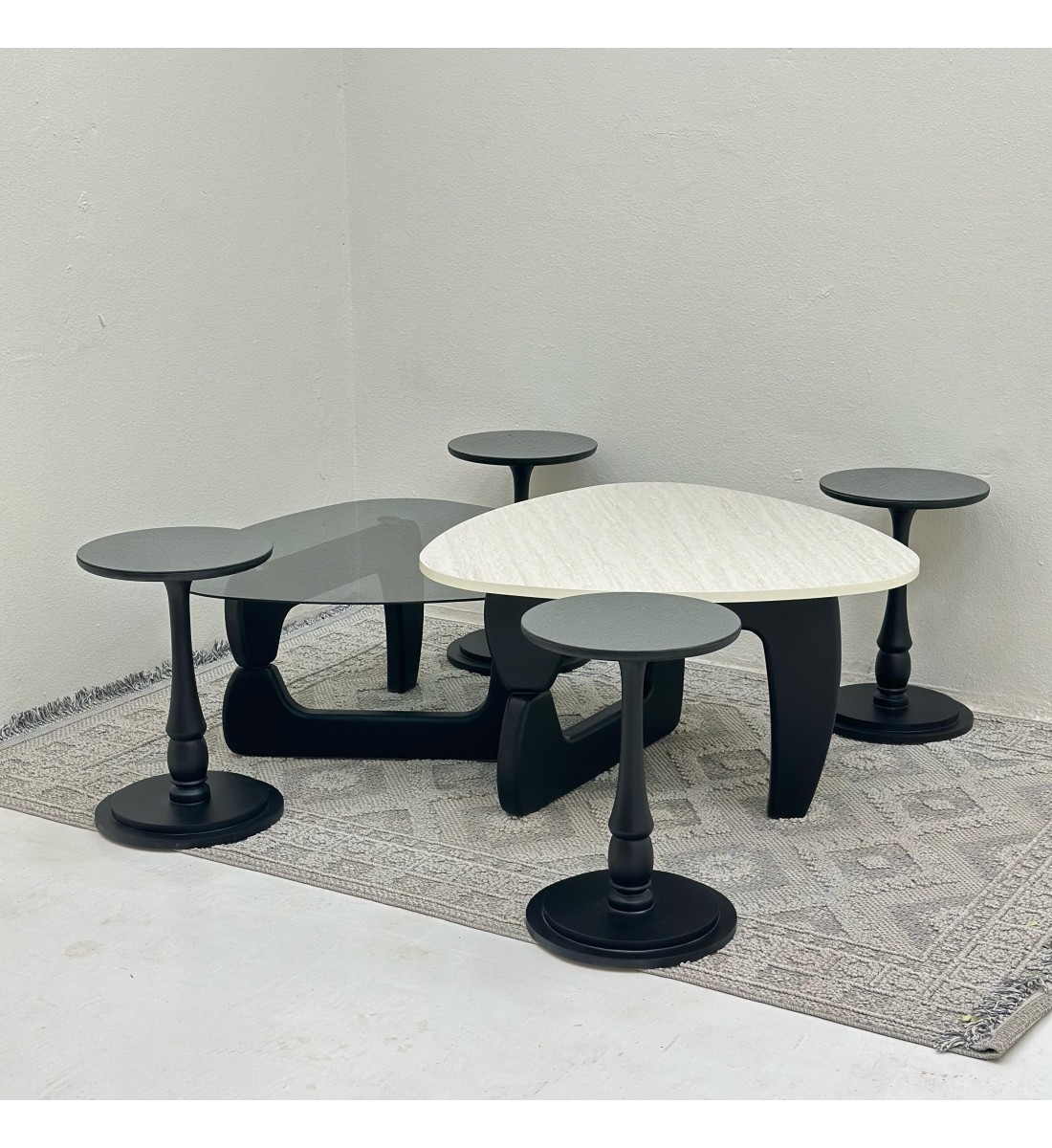 6-piece table set, the first table top is a marble alternative with a smooth texture, and the second table top is glass with black wooden bases.