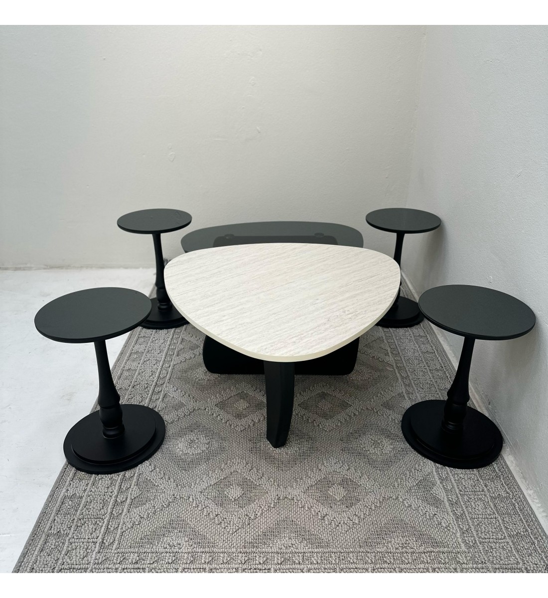 6-piece table set, the first table top is a marble alternative with a smooth texture, and the second table top is glass with black wooden bases.