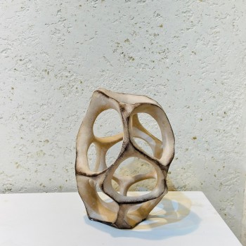 A ceramic decorative masterpiece with a hollow circular design, featuring subtle ripples that add an attractive artistic touch. 27 x 28 x 7 cm