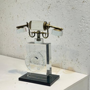 A modern decorative sculpture with an interlocking design of swirling circular rings, measuring 30x9x5 cm.