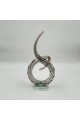 A decorative art piece made of clear glass with a streamlined design inspired by the musical note symbol, 33 x 13 x 8 cm