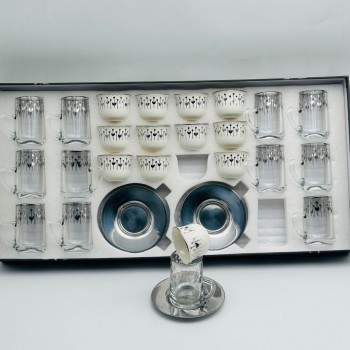 36-piece tea and coffee hospitality set featuring a glass design and elegant calligraphic patterns.
