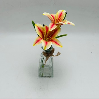 Premium artificial lily flower stems in a clear glass vase.