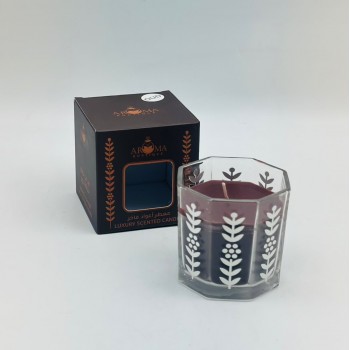 شمع معطر فاخر داخل وعاء زجاجي أنيق متعدد الأضلاع.